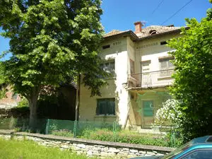 An old house with big yard located in village near lake