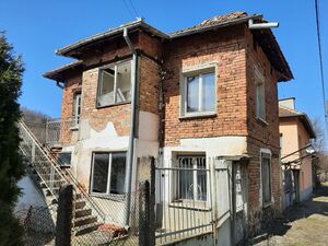 An old house with plot of land located up in the mountains