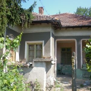 An old rural house with nice plot of land located near the center of a big village near forest and river