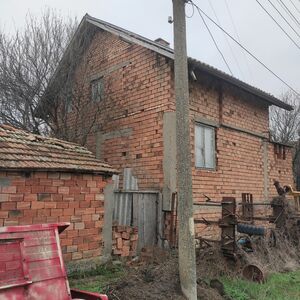 Country house with plot of land in a village near main road